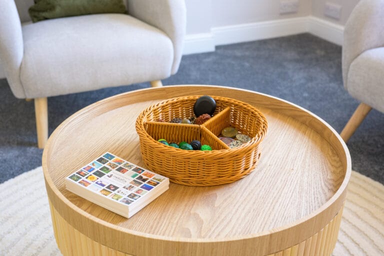 Table with therapy cards and fidgets to support emotional expression in therapy clinic